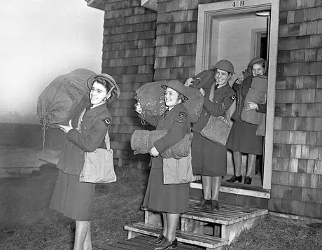 The first of the RCAF Women's Division leave for the Atlantic coast carrying their dunnage bags