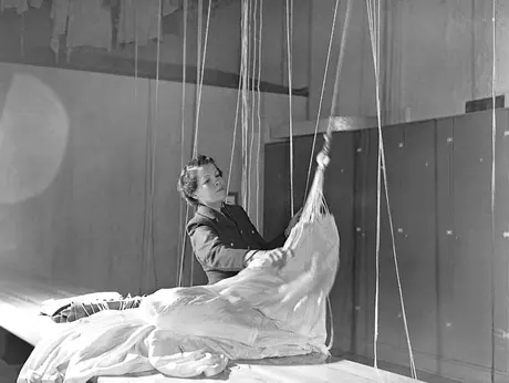 A member of the RCAF Women's Division working in the parachute packing station at an Air Force base