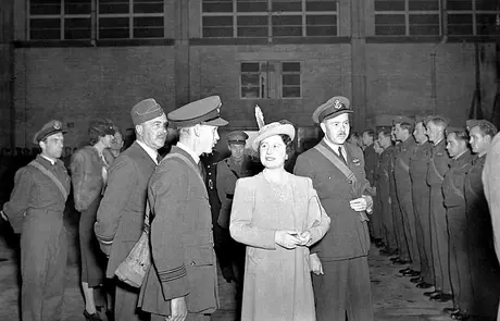 Queen Elizabeth listens to some of the men's exploits