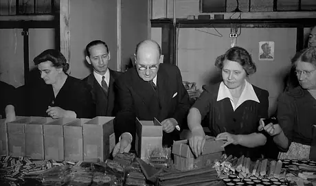 Mr. and Mrs. R.C. Vaughan help CNR volunteers pack Christmas parcels for employees serving in Europe