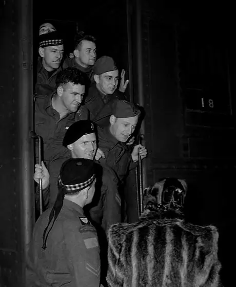 Returned soldiers exit from the door of a hospital train