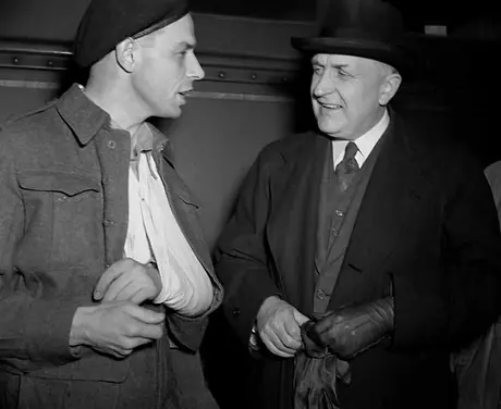 R.C. Vaughan, President of CN, talks with a returned man who has just stepped off a hospital train