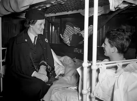 A nurse speaks with one of her patients in a hospital train car
