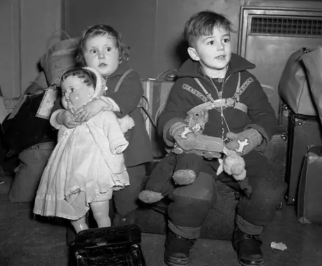 Patsy and David Perry, children of an RAF member stationed in Canada, wait to depart for England