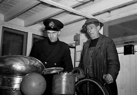 Critchlow checks the CNSS Chomedy's course along with Vienotte--officers and crew wear helmets