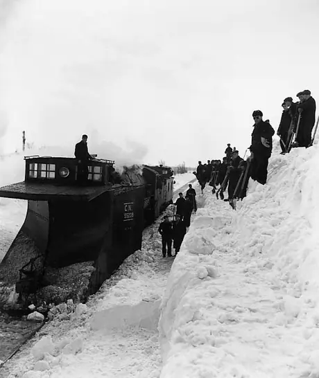 CN wedge snow plow 55238 and a few assistants clearing the way