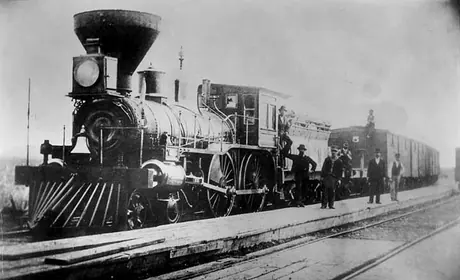 Great Western Railway freight train pulled by a wood burning steam locomotive, three-quarter view
