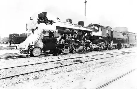 Canadian National Railways steam locomotive 5547 covered in snow at Saskatoon station after passing through a snow storm