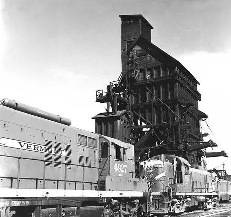 Central Vermont Railways diesel locomotive 3901 and 4927 on the same track to a coaling tower and sand house at St. Albans yard