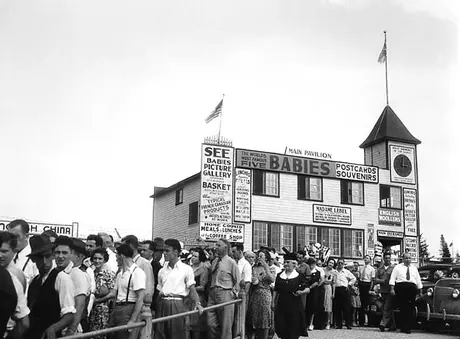 Line-up of visitors to the Quintuplet's home and the Quintland main pavilion