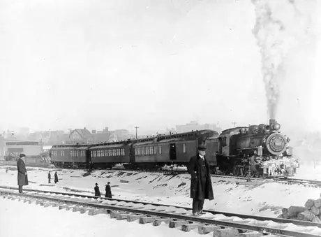 First Grand Trunk Pacific Railway Company train to leave Calgary, shows Canadian Northern Railway Company freight shed at rear left