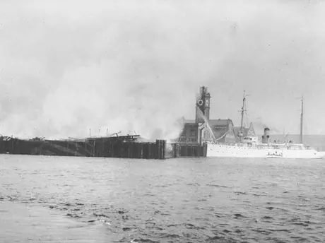 Fighting flames from the shore during Seattle dock fire at the Grand Trunk Pacific Coast  Steamship Company facility