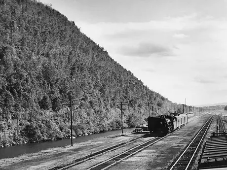 A Canadian National Railways passenger train in mountainous terrain