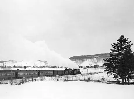 A Canadian National Railways passenger train approaches Hill 70 in winter