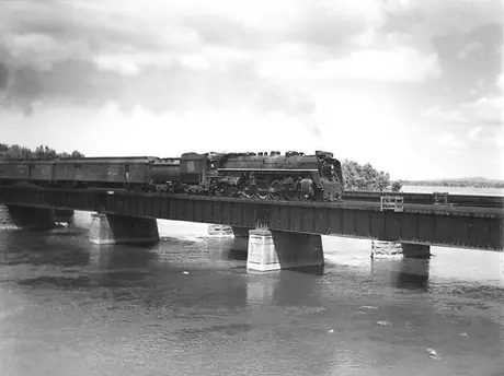 Canadian National Railways steam locomotive no. 6208 hauls a passenger train across St. Anne's Bridge between Île-Perrot and Dorion
