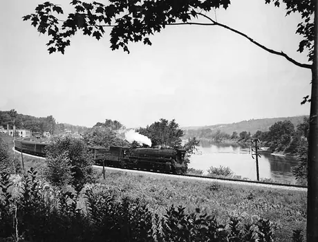A Canadian National Railways passenger train steams through the St. Francis River Valley