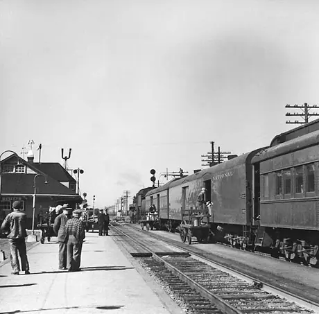 Milk cans being loaded onto a Canadian National Railways train at Coteau Junction