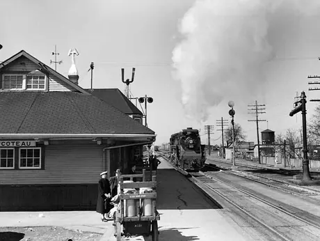 Milk cans await loading at Coteau train station