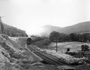 A Canadian National Railways passenger train steams through a valley in Quebec