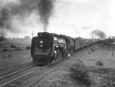 Canadian National Railways steam locomotive no. 6217 hauls a passenger train through Québec countryside
