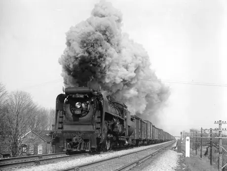 Canadian National Railways steam locomotive no. 6142 hauls a freight train between Toronto and Montréal