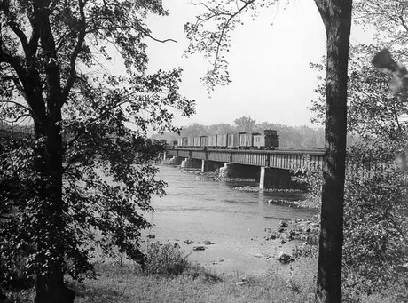 A freight train disappears over a bridge near Vaudreuil