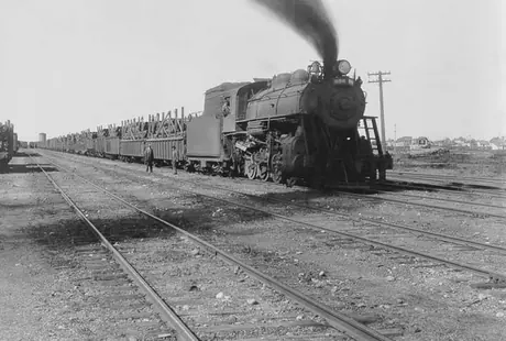 A Canadian National Railway steam locomotive hauls a shipment of Scotch steel pipe