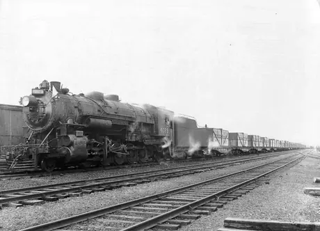 A trainload of coated Chevrolet automobile parts for export being hauled on Canadian National Railways Maritime Lines by steam locomotive no. 4029