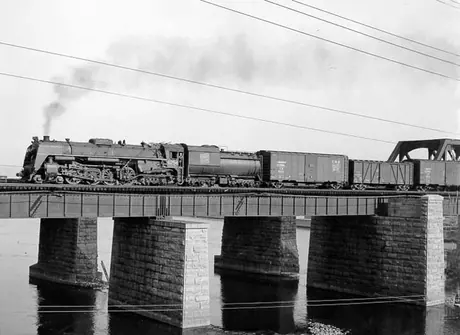A freight train on St. Anne's Bridge hauled by Canadian National Railway locomotive no. 6254