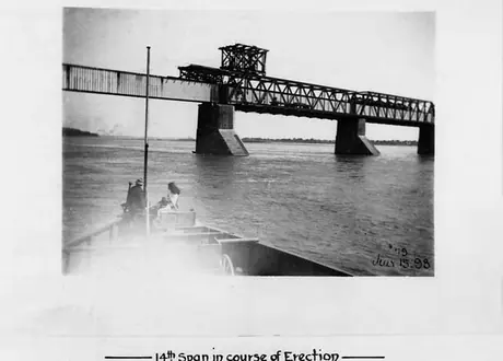 Victoria Bridge reconstruction: the 14th span being erected - viewed from a boat on the river