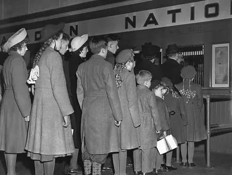 A family of Dutch immigrants lines up to receive their train tickets