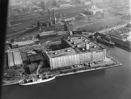 A dockside warehouse at Queen's Quay with Toronto rail yard in background
