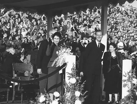 Princess Elizabeth and the Duke of Edinburgh greet a large crowd of well-wishers at Hamilton Civic Stadium