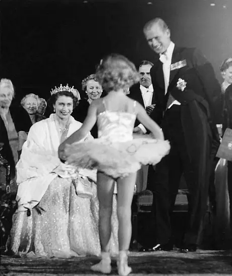 Princess Elizabeth and the Duke of Edinburgh receive a young admirer at a ballet during a Royal Tour of Canada