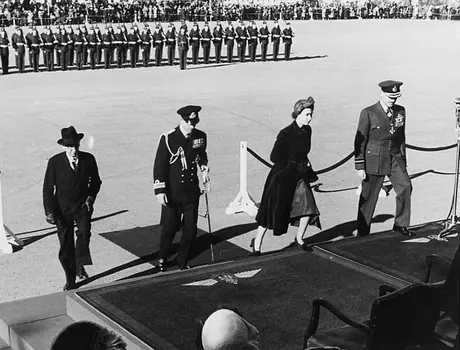 Princess Elizabeth and the Duke of Edinburgh ascend to the podium at Royal Canadian Air Force Base Trenton