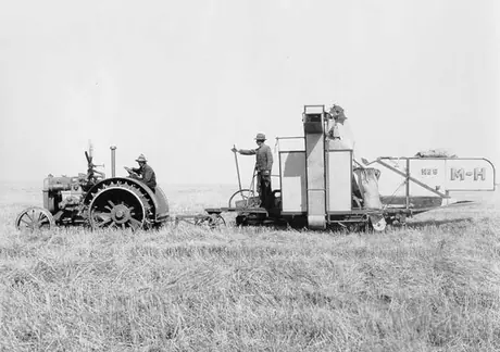 A tractor-drawn Massey-Harris No. 9 Reaper-Thresher
