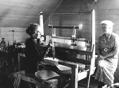 Ladies weaving on a hand-operated loom