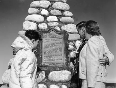 Tourists examine historic marker for Fort Churchill