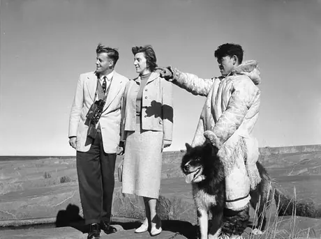 Visitors with Inuk guide and Husky sled dog