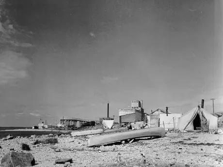 An Aboriginal settlement with the harbour and grain elevator in the background