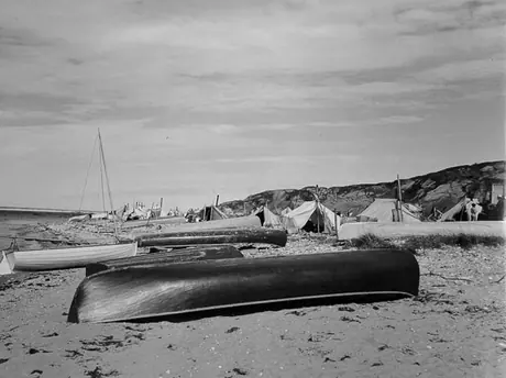 Freighter canoes on the beach at an Aboriginal encampment