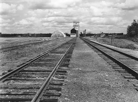 Grain elevator, service structure and railway station at a prairie railway stop