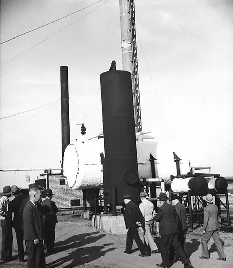 Executives tour a cleaning plant at the Vermillion oil fields