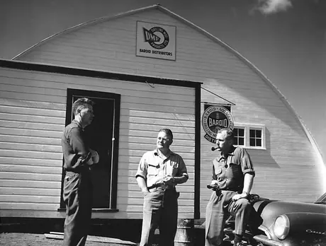 Canadian National Railway Industrial Agent (left), confers with representatives from an oil drilling equipment distributor in front of their new warehouse