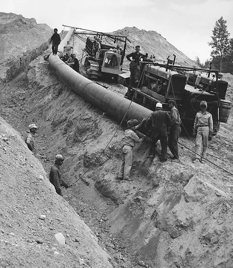 Welders preparing pipe to be joined