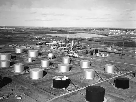 A field of oil storage tanks near a refinery