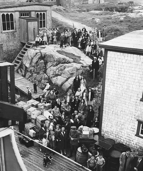 Passengers wait to board a ship