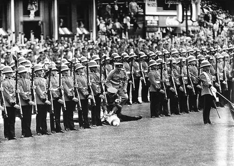 A guardsman faints during a ceremony honouring their Majesties King George VI and Queen Elizabeth during the 1939 Royal Tour of Canada
