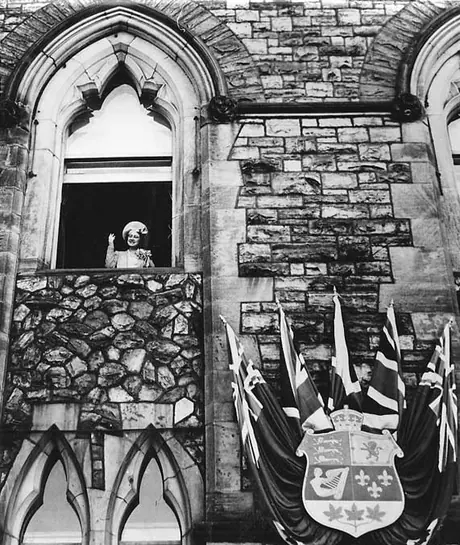 Her Majesty Queen Elizabeth waves to the crowd from a window of the Parliament Buildings during the 1939 Royal Tour of Canada