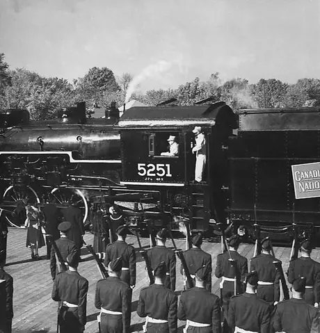 Canadian National Railways steam locomotive no. 5251 hauls the Royal Tour train carrying Princess Elizabeth and the Duke of Edinburgh into the Island Park siding